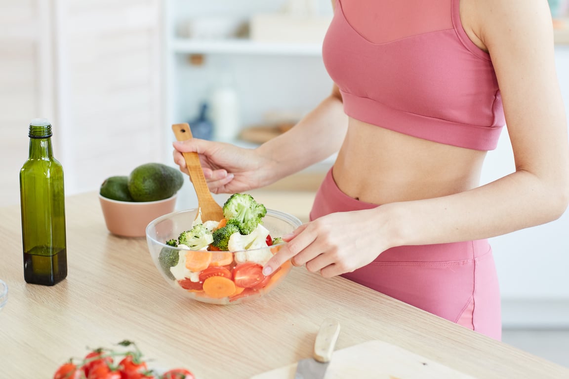 Young Woman Cooking Healthy Salad